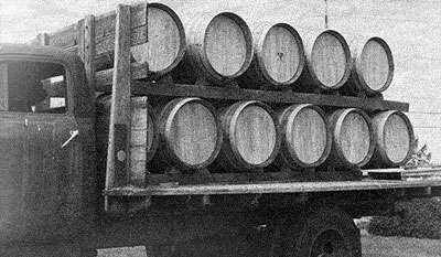 Old truck transporting barrels of tequila.