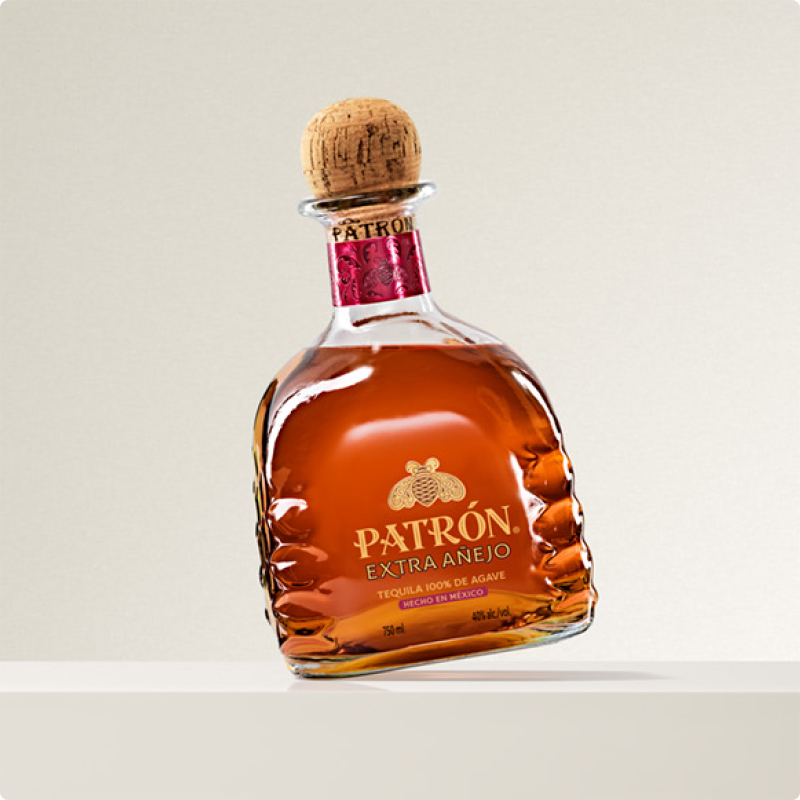 Patrón Extra Añejo Tequila bottle and cocktail.