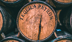 Close up of brown aged barrel labeled “Tequila Patron”.
