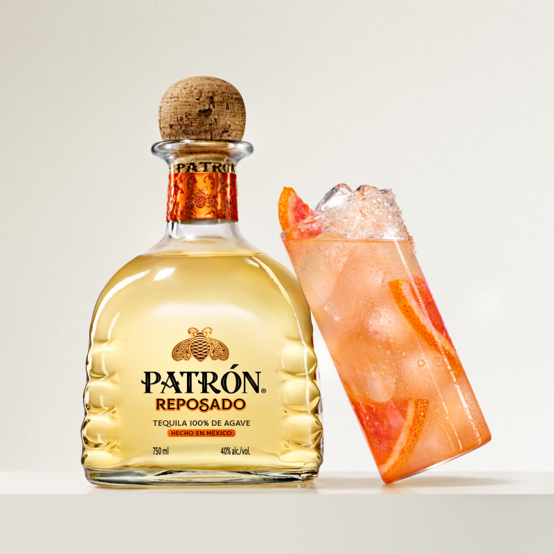 Bottle of Patrón Reposado and a paloma cocktail.